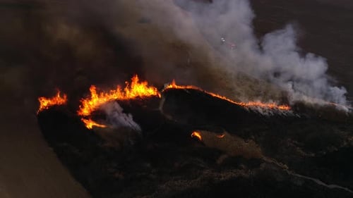 Raging Wildfire Consumes Dark Natural Landscape from Above