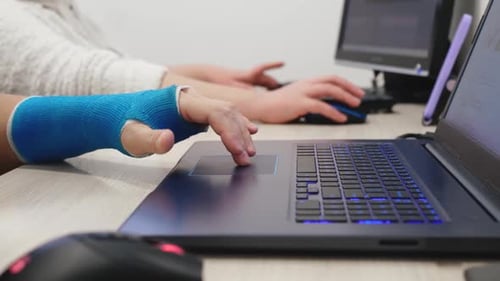 Typing on Laptop with Arm in Blue Cast