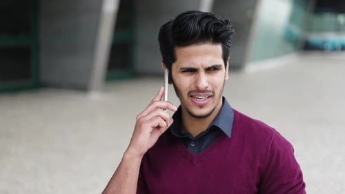 Man Talking on Cell Phone in Urban Setting