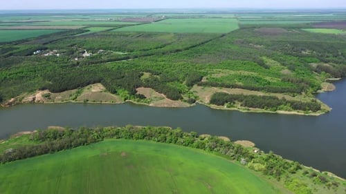 Aerial View of Serene River Flowing Through Forest