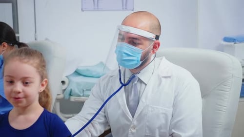 Doctor Giving Girl Checkup in Doctor Office