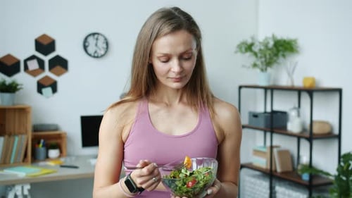 Woman in Exercise Outfit Eating a Healthy Salad