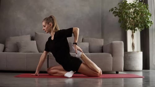 Flexible Woman Practice Yoga Postures and Doing Stretching in Loft Interior Room Slim Girl Doing