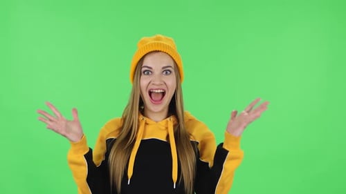 Portrait of Modern Girl in Yellow Hat with Shocked Surprised Wow Face Expression Is Rejoicing. Green