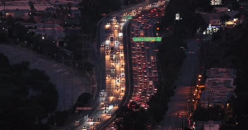 Night Scene of Busy Multi-lane Highway with Cars Driving in Different Directions