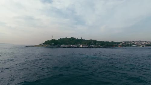 the Boat Quickly Makes a Circle Around the Island with Beautiful Green Fields