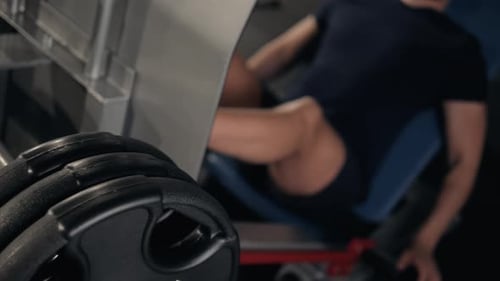 Man Using A Press Machine In A Fitness Club