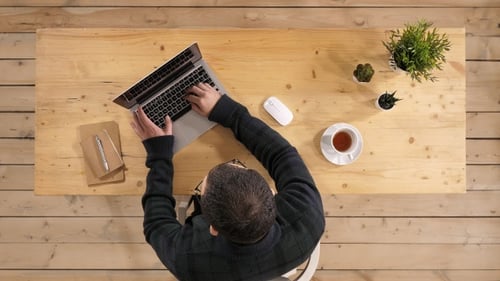 Casual man working on laptop in casual office