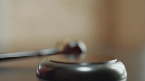 Judge is Hitting Gavel Off a Block in Courtroom