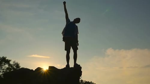 Silhouette Man Hiking Celebrating Mountain Summit at Sunrise