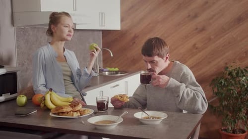 Young Adults Eating Breakfast in Kitchen Together
