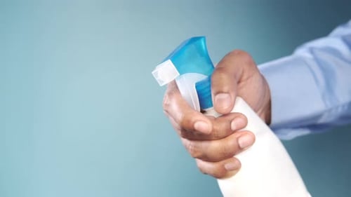 Holding Spray Bottle for Cleaning and Disinfecting Something with Copy Space