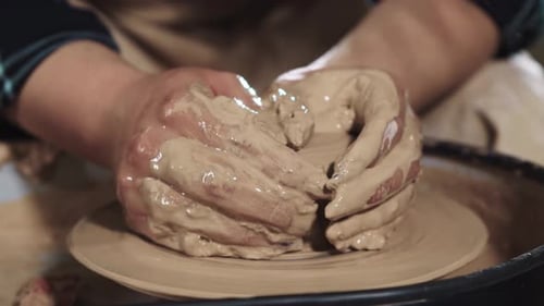 Hands Shaping Clay on Pottery Wheel