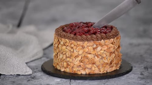 Cutting a Delicious Almond and Cherry Cake