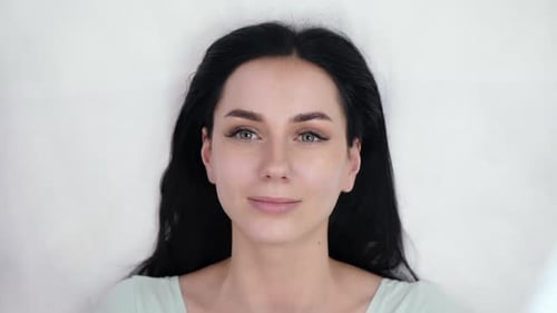 Beautiful Brunette Woman Posing Against White Backdrop