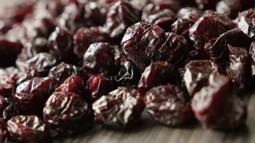 Slow pan over dehydrated cranberries on pile 4K 2160p 30fps UltraHD footage - Heap of red dried ber