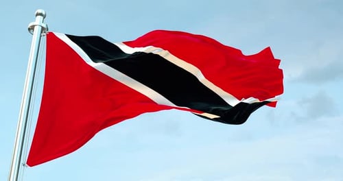 Trinidad and Tobago Flag Waving Against Blue Sky