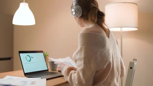 Female Financial Analyst on a Remote Work at Home Working with Documents and Financial Statements