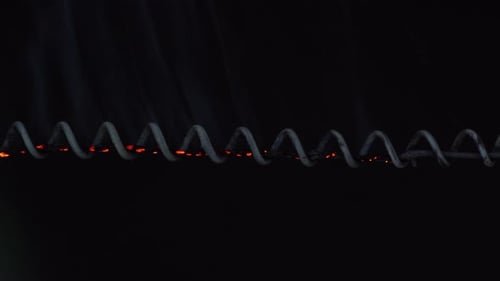 Burning Metal Wire with Sparks and Smoke