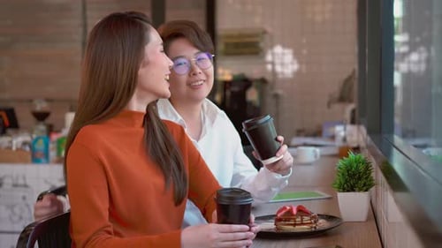 Two Friends Talking in a Bright Cafe