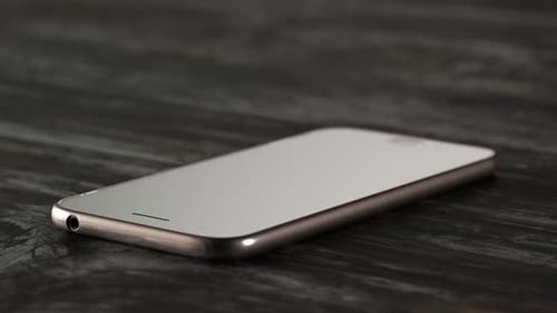 Hammer smashes smartphone in slow motion. Angry destroying mobile technology.