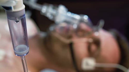 Intravenous Drip in Focus,surgeons Team Performing Operation in the Background,out of Focus, infusion