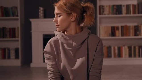 Female Meditating in House with Fireplace
