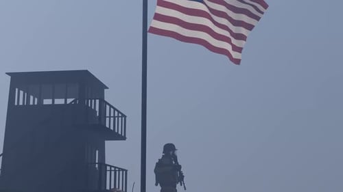 American Flag and Soldier at Military Outpost