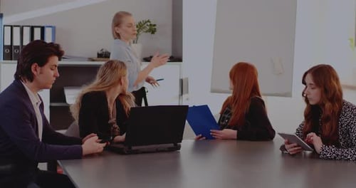 Young Adults Meeting in Workplace at Table
