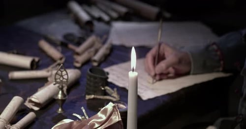 Writing Letter by Candlelight in Historical Setting