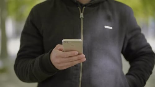 Young Adult Using Smartphone in Urban Environment
