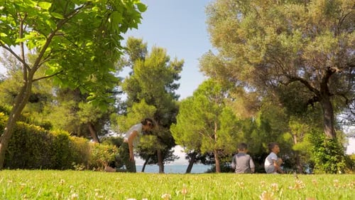 Children Exercising Outdoors Near Lush Trees on Grass