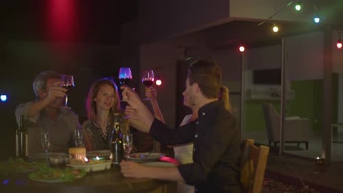 Friends Celebrate with Wine at Night