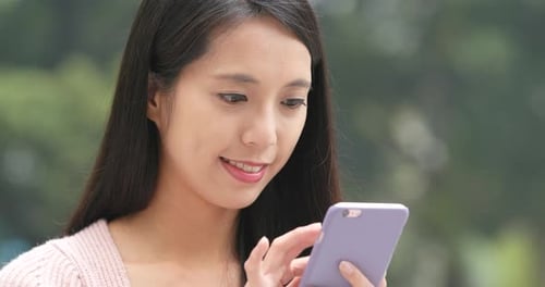 Woman Using Smartphone in Urban Setting Close Up