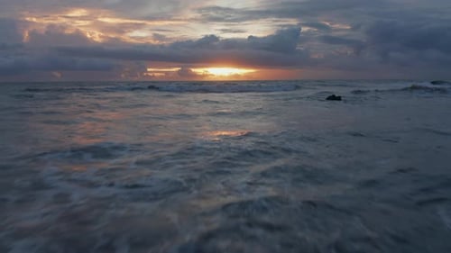 Low Aerial Shot of Rough Sea Waves During Golden Sunset in Bali
