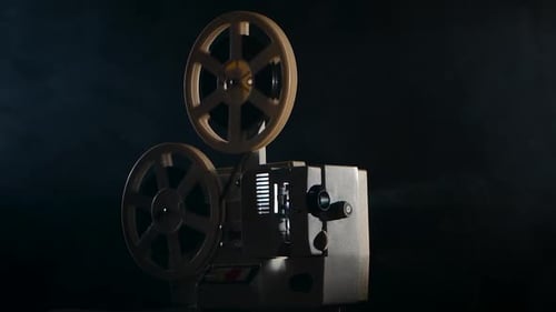 Vintage Film Projector Projecting Light in Dark Room