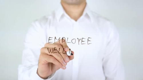 Writing Employee Wellness on Glass Surface