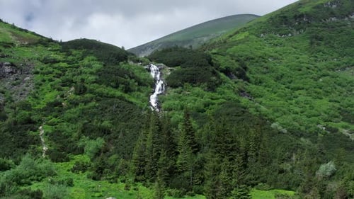 Scenic Waterfall Cascading Down Green Mountain