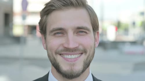 Close Up of Businessman Smiling at Camera Outdoor