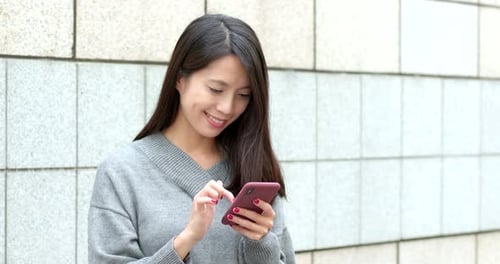 Woman Using Smartphone in Urban Setting