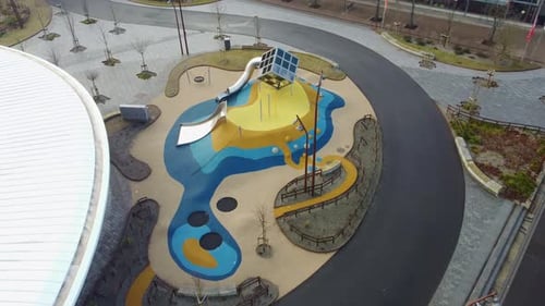 Closeup aerial of public playground in Sandnes city park close to bus terminal - Artistic design