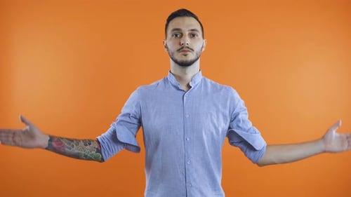 Young Man in Casual Clothes Standing with Closed Eyes in Praying Gesture. Wish for Something To