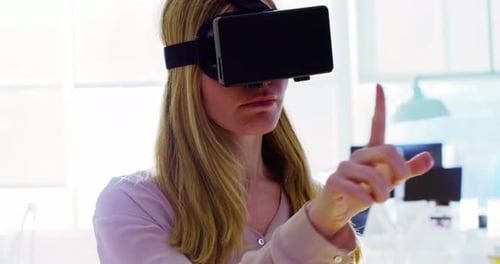 Woman Interacts with Virtual Reality Headset in Office
