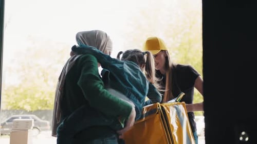 Food Delivery Person Delivers Pizza to Family