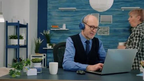 Mature Man on Laptop in Home Office
