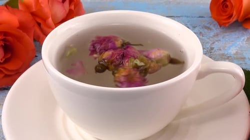 Rose Tea Brewing in White Cup with Flowers