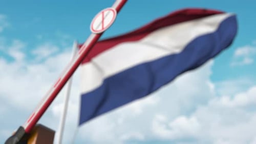 Coronavirus Restriction Barrier and Waving Netherlands Flag