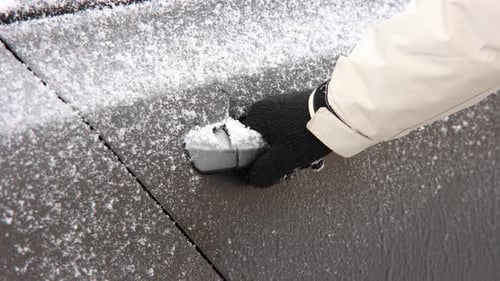 Hand Pulling Frozen Car Door Handle To Open