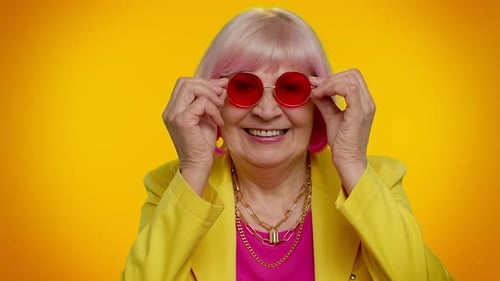 Stylish Senior Woman with Pink Hair Winks