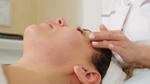 Woman Receives Relaxing Facial Massage at a Spa